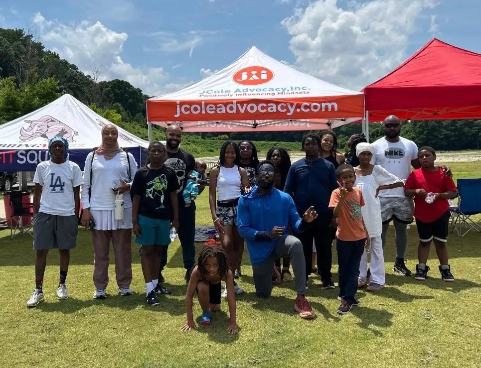 FitSquad community group gathered together at an outdoor event under tents